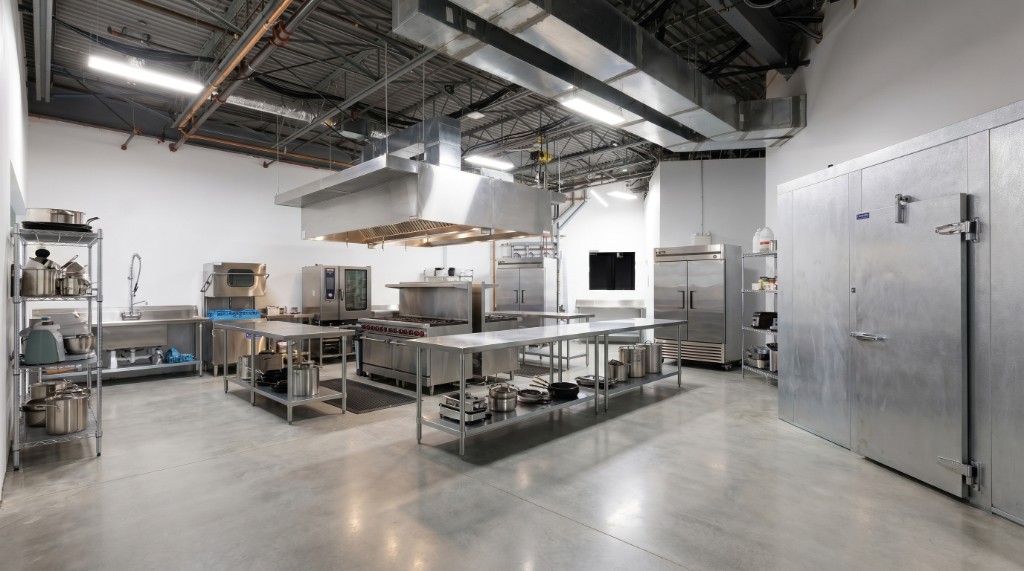 Commercial kitchen with prep stations and professional cooking equipment